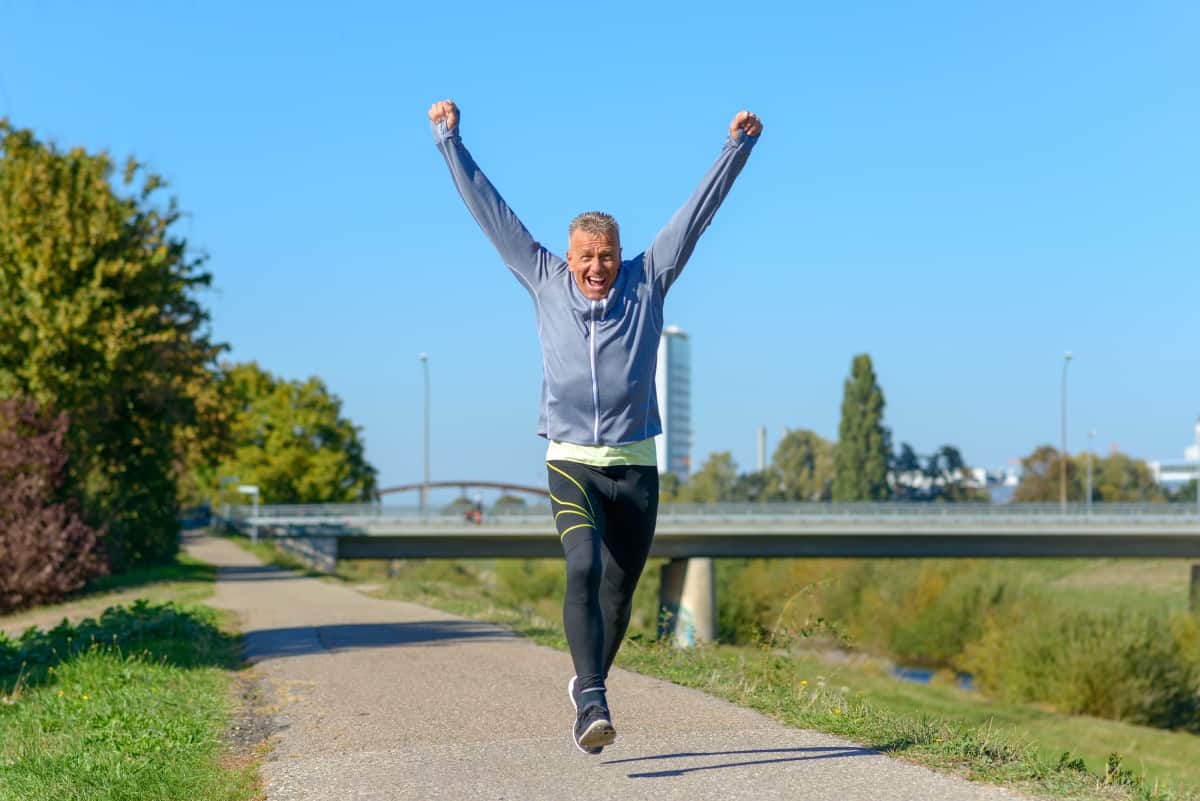 Happy Fit Middle Aged Man Cheering And Celebrating As He Walks A