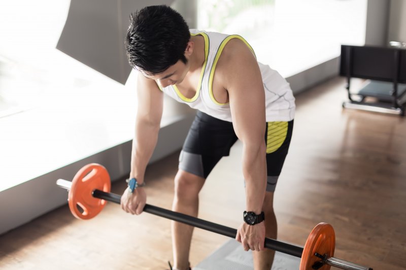 man performing bent over barbell row