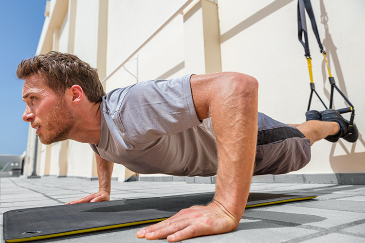 man doing suspended pushup